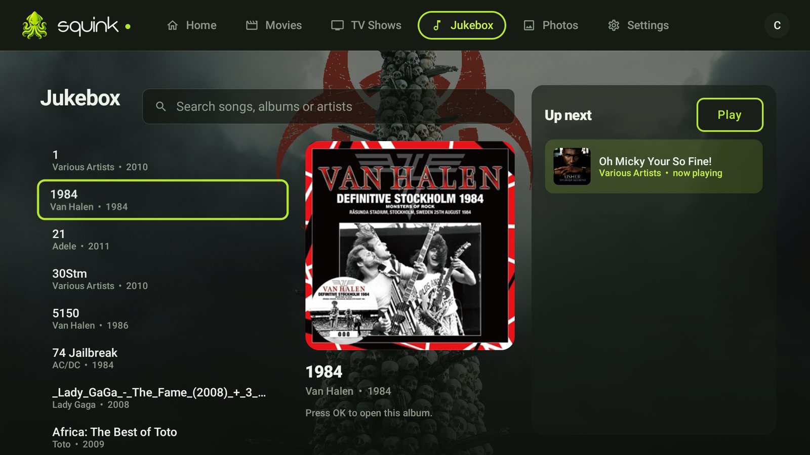 The Squink Jukebox on a TV — album browser with pop-out covers and the live house queue